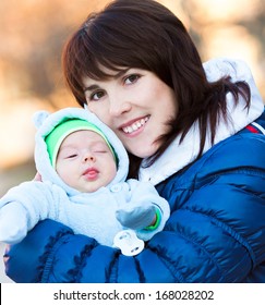 Young Mother With Newborn Baby In Winter Day