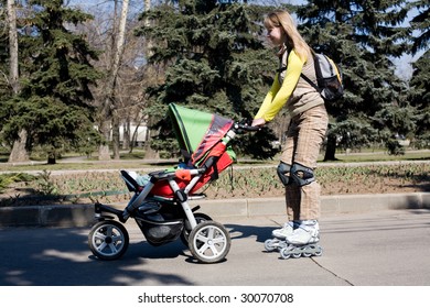 Young mother on roller skates with baby carriage