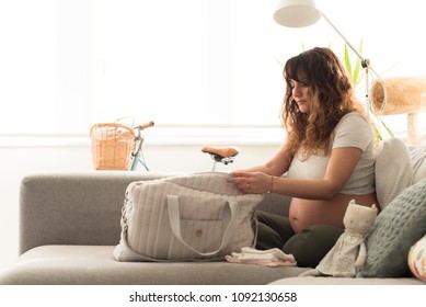 Young Mother Organizing The Baby Maternity Bag