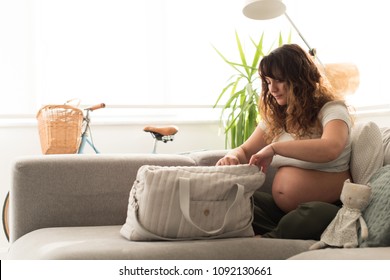 Young Mother Organizing The Baby Maternity Bag