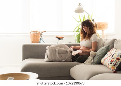 Young Mother Organizing The Baby Maternity Bag