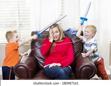 Young Mother overwhelmed by her kids - Powered by Shutterstock