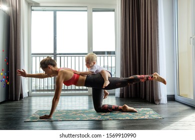 Young mother practices yoga at home with her baby - Powered by Shutterstock