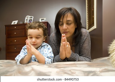 Young mother praying with child