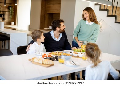 Young mother preparing breakfast for her family in the modern kitchen - Powered by Shutterstock