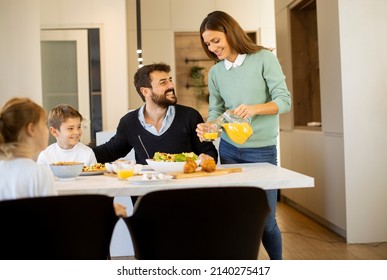 Young mother preparing breakfast for her family in the modern kitchen - Powered by Shutterstock