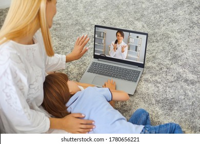 Young Mother And Sick Little Boy Using Online Medical Service At Home, Consulting Pediatrician Through Video Chat