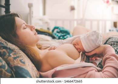  young mother  sleep and brest feeding newborn baby 