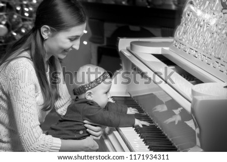 Similar – child girl playing checkers with her dad