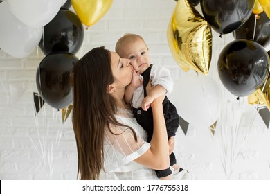 Young mother and son with balloons. Birthday