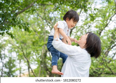 a young mother and son enjoy a picnic together in a park. - Powered by Shutterstock