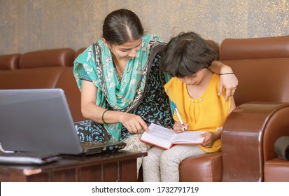 Young Mother Teaching Her Child While Working On Laptop - Concept Of People Lifestyles And Technology, Work Form Home Or Wfh Reality.