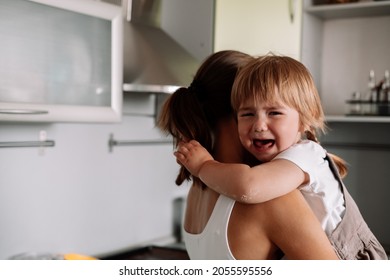 Young mother tries to calm her crying little daughter. Raising  child concept.