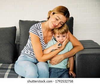 Young Mother Trying To Comfort And Calm Down Her Crying Child
