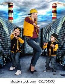 A Young Mother And Two Young Sons In The Style Of Hip Hop.Fashionable Family.Graffiti On The Walls.	