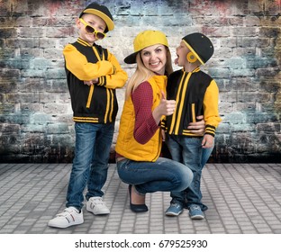 A Young Mother And Two Young Sons In The Style Of Hip Hop.Fashionable Family.