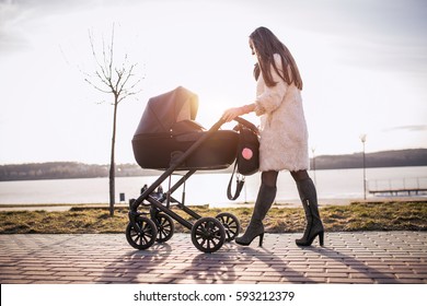 young mother walking with baby, good weather for walking, healthy lifestyle