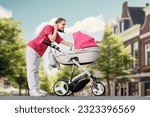 A young mother walks with her child around the city in a stroller. A woman in a pink T-shirt walks with her newborn baby in the city