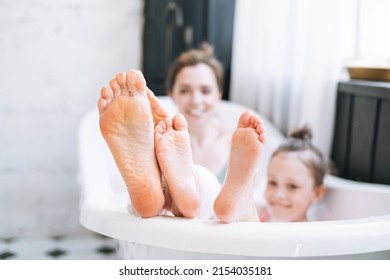 Young Mother Woman And Little Tween Girl Daughter Having Fun In Bath With Foam At Home