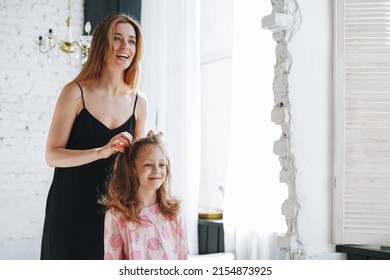 Young Mother Woman With Long Hair In Black Dress And Little Tween Girl Daughter In Pajamas Having Fun In The Morning At Home, Family Spending Time Together In Bathroom