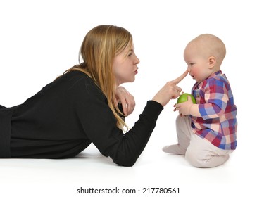 Young Mother Woman Touching Nose Of Infant Child Baby Girl Toddler Smiling And Holding Green Apple In Hands On A White Background