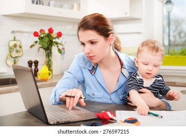 Young mother working with her baby at home