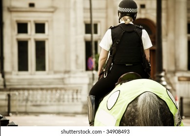 Young Mounted Policewoman Patrolling In London