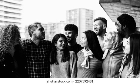 Young multi ethnic friends having fun together hanging out in the city - Friendship and diversity concept - Black and white editing - Shutterstock ID 2207592481