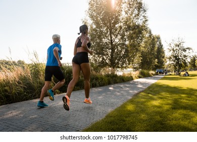 Young Multi Ethnic Joggers Running Together In Park