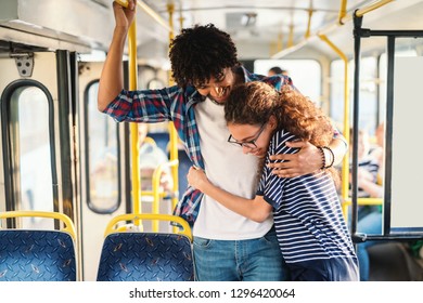 Young Multicultural Couple Hugging In The Public Transport.