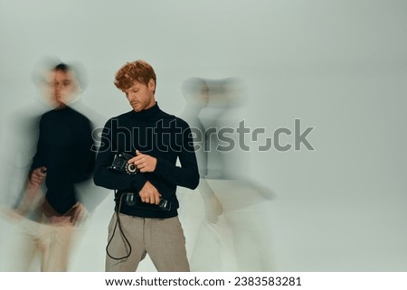 young multicultural trio posing with retro phone posing in motions, long exposure, men power