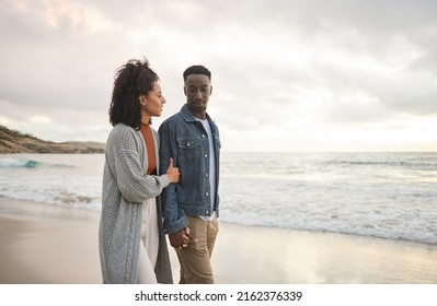 Young multiethnic couple holding hands and walking on a sandy beach - Shutterstock ID 2162376339