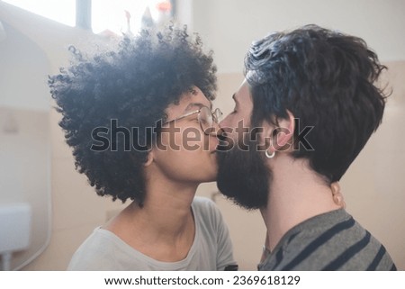 Young couple kissing in a studio portrait