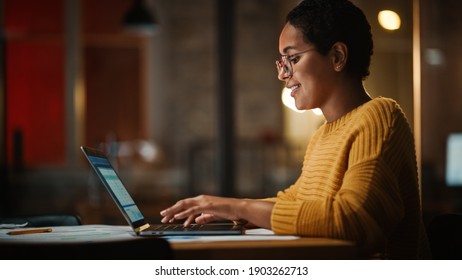 Young Multiethnic Developer Working On A Laptop Computer In Creative Office Environment. Beautiful Diverse Latin Female Project Manager Is Developing Data And Scheduling A Project.