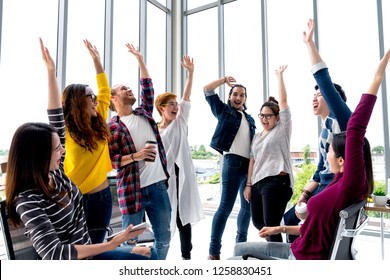 Young Multiethnic Diverse Creative Asian Group Huddle And High Five Hands Together In Office Workshop With Success Or Empower Expression In Teamwork. Young Asian Marketing Team With Copy Space.