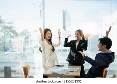 Young multiethnic diverse creative asian group huddle and high five hands together in office workshop with success or empower expression in teamwork. Young asian marketing team with copy space - Shutterstock ID 2155201331