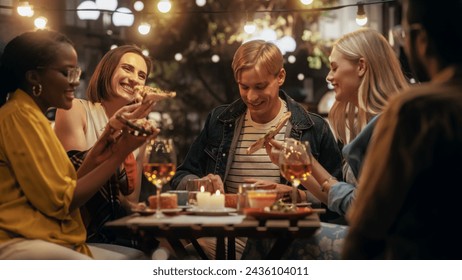 Young Multiethnic Friends Enjoying a Night Out in a Cafe. Eating Delicious Italian Pizza. Young Men and Women Having Fun Conversations on a Terrace, Enjoying Tasty Food and Beverages - Powered by Shutterstock