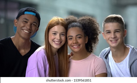 Young Multiethnic Friends Hugging And Smiling Camera, High School Classmates