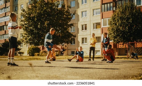 Young Multiethnic Kids Playing with Ball in the Neighborhood. Young Boy Practicing Soccer Drills, Controlling the Ball in the Air. Friends are Clapping and Cheering for Him. - Powered by Shutterstock