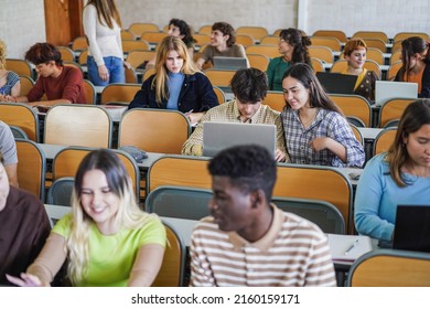 Young multiethnic students working with tablets inside classroom at school university - Focus on center girl face