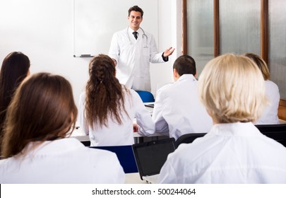 Young Multinational Students And Attractive Professor Having Discussion At Medical Faculty