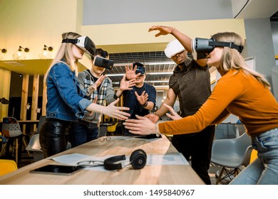 Young multiracial business People wearing virtual reality goggles with touching air during VR Meeting Conference at the office. Business men and women using VR goggles in meeting room. - Powered by Shutterstock