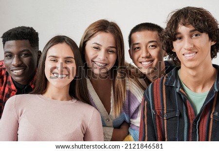 Young multiracial friends smiling on camera - Diverse people and friendship concept