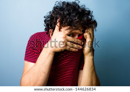 Young multiracial man does not dare to look