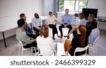 Young Multiracial Millennial Friends Sitting In Circle Having Group Discussion