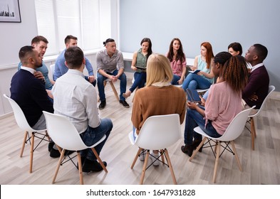 Young Multiracial Millennial Friends Sitting In Circle Having Group Discussion - Shutterstock ID 1647931828