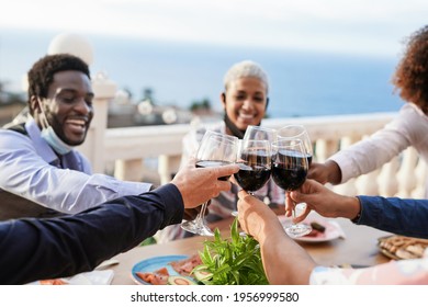 Young Multiracial People Cheering With Wine - Dinner Outdoor While Wearing Protective Face Mask For Coronavirus