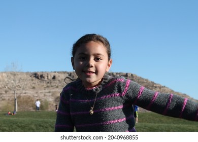 Young Multiracial Samoan Girl Playing Outside At Park