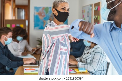 Young Multiracial Workers Wearing Face Mask Doing New Social Distance Greetings Bumping Elbows Inside Co-working Creative Space 