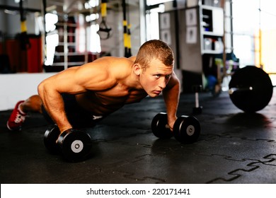 Young muscular athlete doing pushups - Powered by Shutterstock